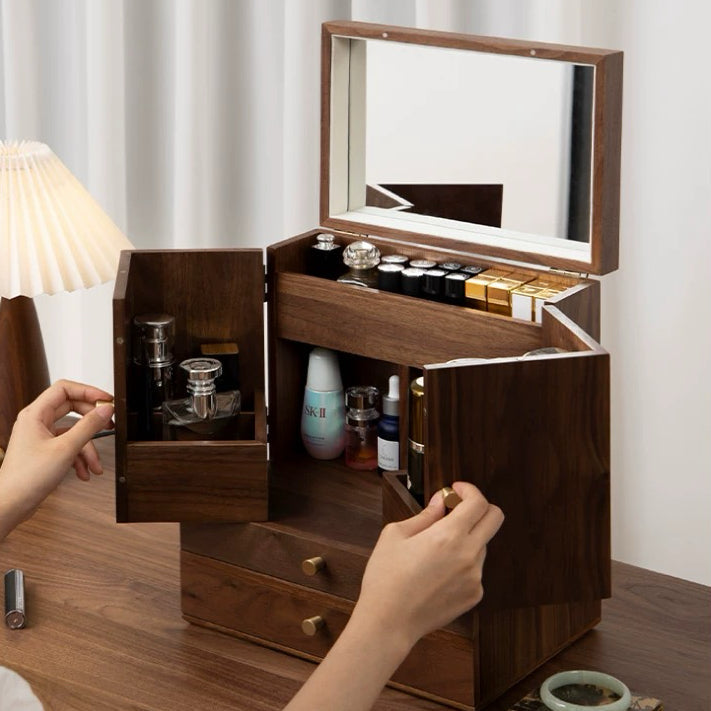 Wooden makeup organizer with mirror and compartments filled with beauty products on a wooden surface.