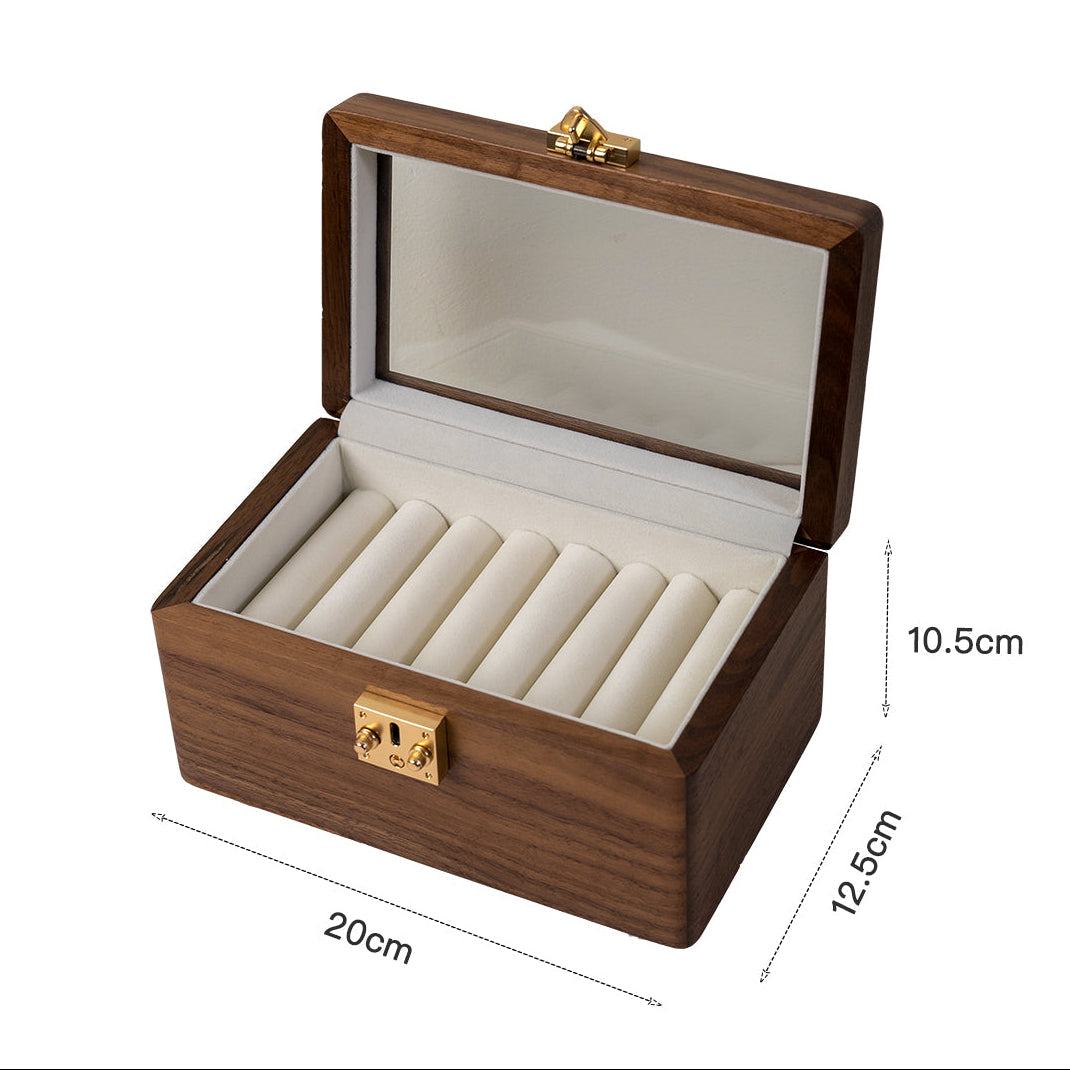 Neatly stacked bangles inside minimalist black walnut box