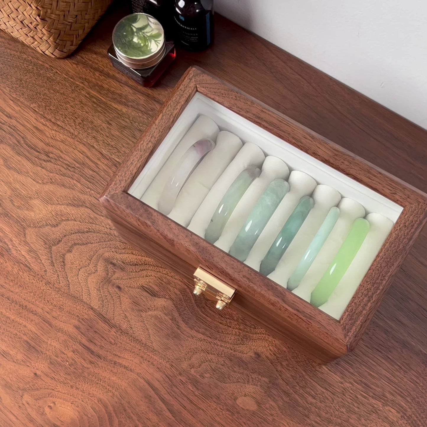 Open black walnut box showing neatly arranged bangles
