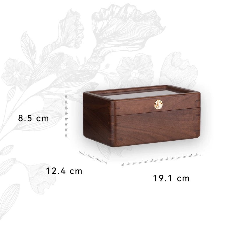 Premium walnut watch box showcasing watches through glass lid