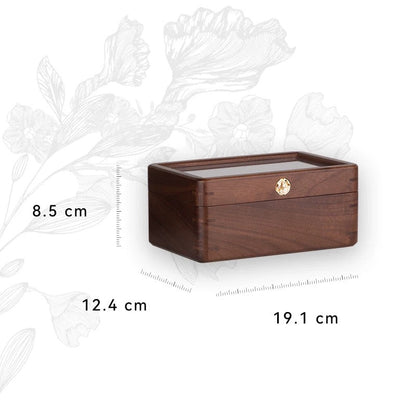 Premium walnut watch box showcasing watches through glass lid