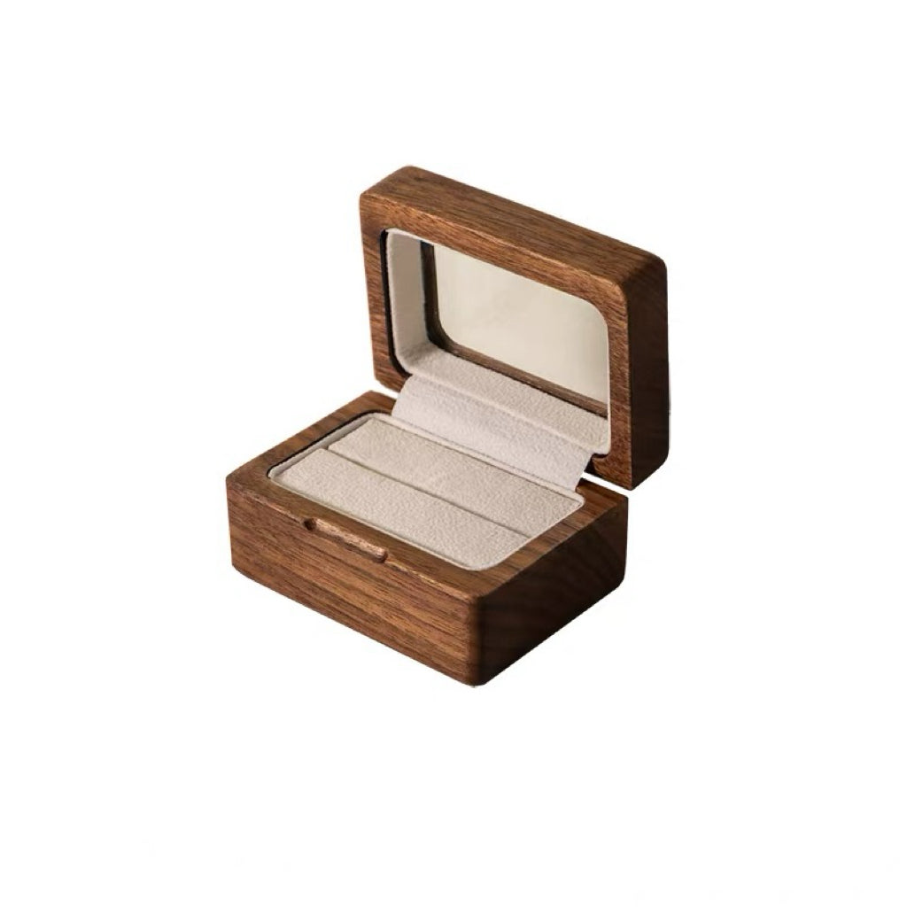 Wedding ring nestled inside natural wood ring box