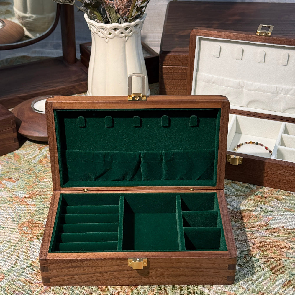 Wooden jewelry box with green interior on a floral-patterned surface